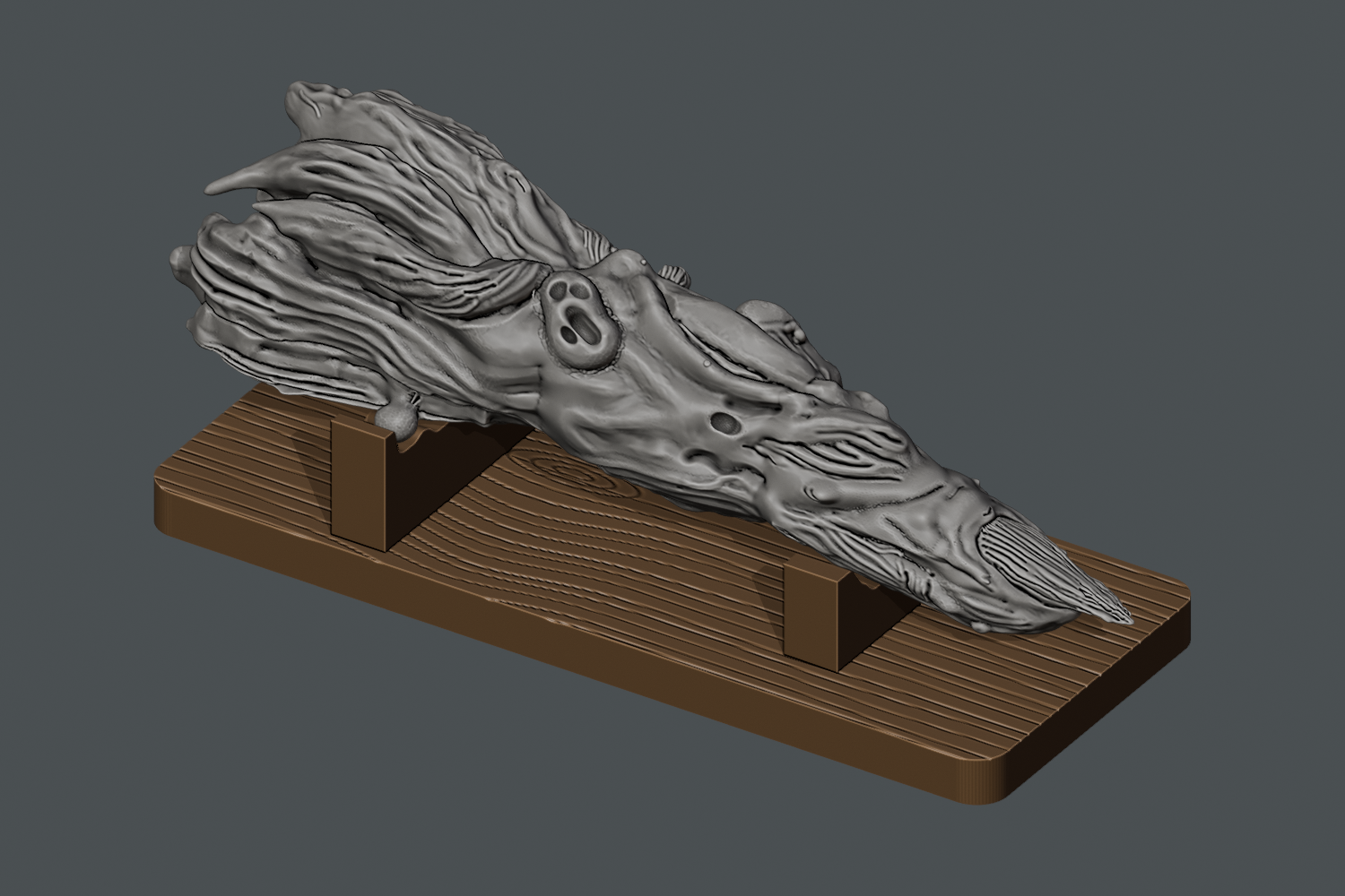 Digital render of the textured 120 mm Sukuna finger resting in two open cradles on a separate wood-grain display stand